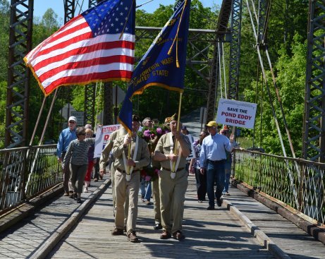 Members of the Tusten, Highland Lumberland VFW Post #6427 lead a procession of veterans and activists on the Pond Eddy Bridge, which is also named All Veterans Memorial Bridge, to drop a wreath into the water on Armed Forces Day, and to call for the preservation of the historic structure.