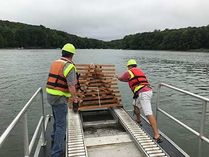 The porcupine cribs are launched into Lake Wallenpaupack to foster safer habitat for fish and improved fishing opportunities for anglers.