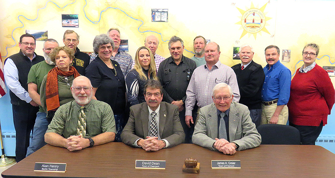 Newly-inducted Upper Delaware Council officers pictured seated at UDC’s February 2 meeting are Secretary-Treasurer Alan F. Henry of Berlin Township, left; Vice-Chairperson David M. Dean, of the Town of Deerpark; and Chairperson James A. Greier, of the Town of Fremont. Standing from the left are Steve Tambini, of the Delaware River Basin Commission; Michael Barth, of Westfall Township; Jeff Dexter, of Damascus Township; Susan Sullivan, of the Town of Tusten; Fred Peckham, of the Town of Hancock; Virginia Dudko, of the Town of Deerpark; Zoriana Gingold, of the Town of Lumberland; Larry Richardson, of the Town of Cochecton; Aaron Robinson, of Shohola Township; Doug Case, of Lackawaxen Township; Jeff Haas, of the Town of Highland; Harold Roeder, of the Town of Delaware; Bill Rudge, of the New York State Department of Environmental Conservation; and Carla Hahn, of the National Park Service Upper Delaware Scenic and Recreational River.