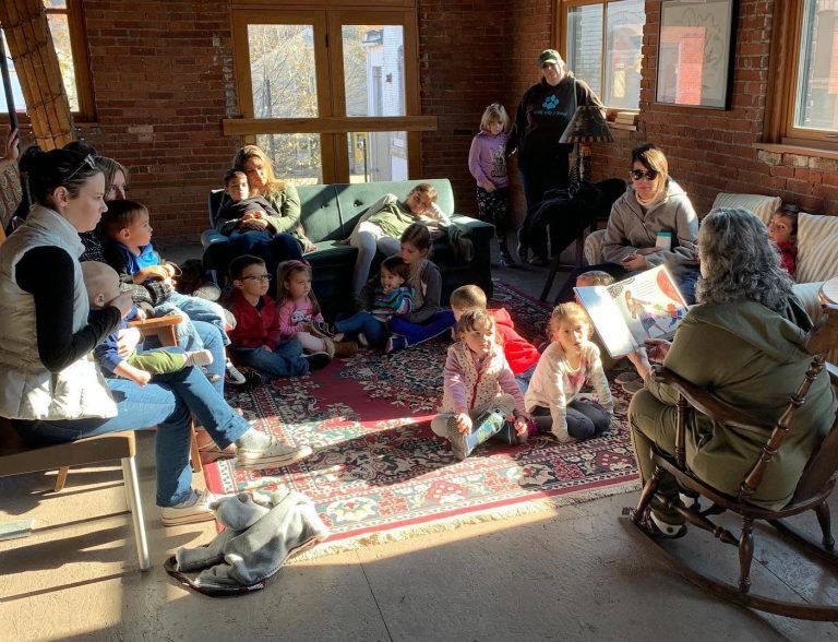 SEEDS volunteer Heidi Rothstein Finkelberg reads to children during the Romping Radishes program at the Cooperage as part of the new SEEDS Reads initiative.