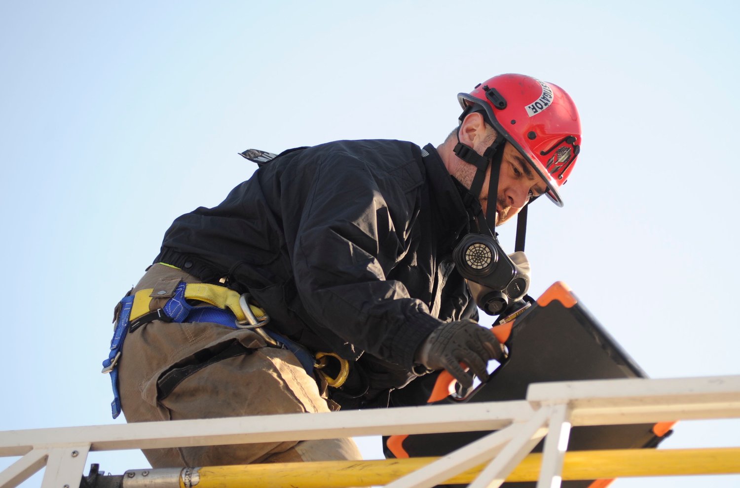 Fire Investigator Mike Barrett of the Sullivan County Bureau of Fire uses the Youngsville Volunteer Fire Department (VFD) aerial apparatus to access the roof of Sama Café after the blaze was extinguished.