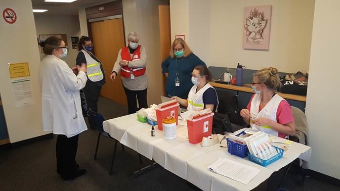 Public Health Services staff Amanda Wolfe, RN, CHN; left, April Novello, RN, SPHN; Beverly Franskevicz, RN, SPHN; Wendy Brown, RN, MS, Deputy Director; Christina Haff, RN, CHN, MPH; and Sue Flynn, RN prepare to welcome well over 150 local first-responders who came January 21 to get their COVID-19 vaccinations. The county is seeking vounteers to register and do non-medical tasks.