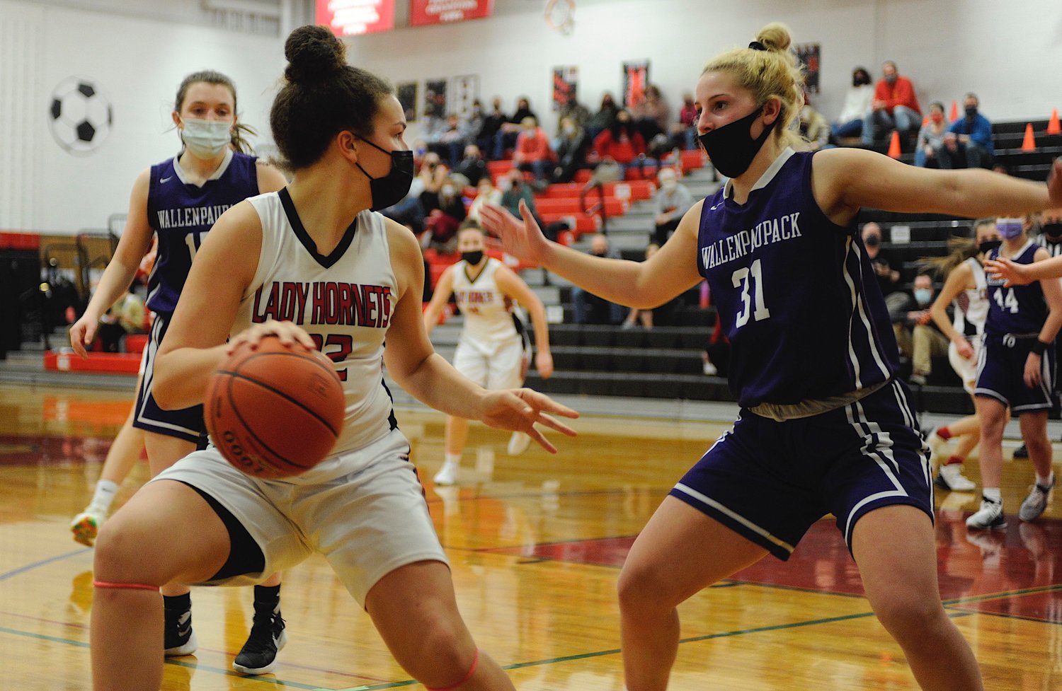 On the attack. Honesdale’s Mia Land goes up against Wallenpaupack’s Aviona Rosenthal.