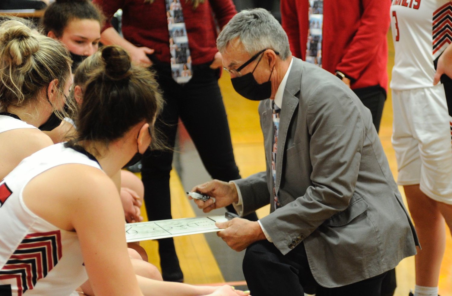 Listen up!  Honesdale’s coach Ron Rowe calls a time out to discuss strategy with the Lady Hornets.