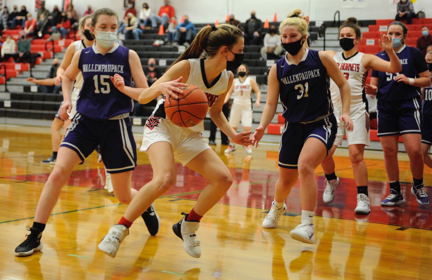 Airborne. Honesdale’s Katie Ludwig gets a little air under her sneakers as she splits the Lady Buckhorns defense of Megan Desmet and Aviona Rosenthal. Desmet posted a game high of 26 points.