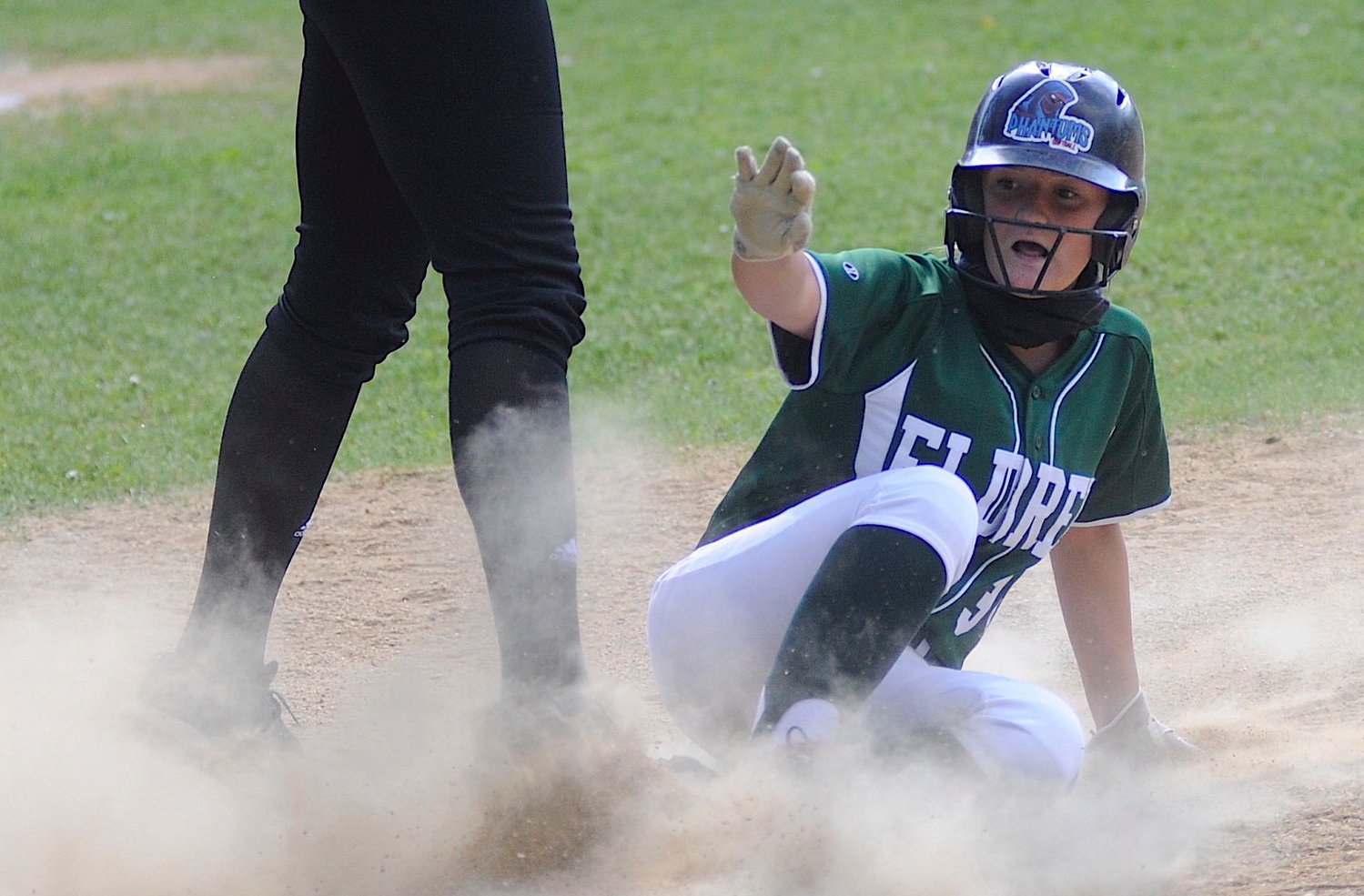 Dust devil. Eldred’s ace pitcher Dana Donnelly makes it safely back to first on Sullivan West’s Taylor Wall. See the special coverage of Donnelly, who on May 14, posted a perfect game against Seward.