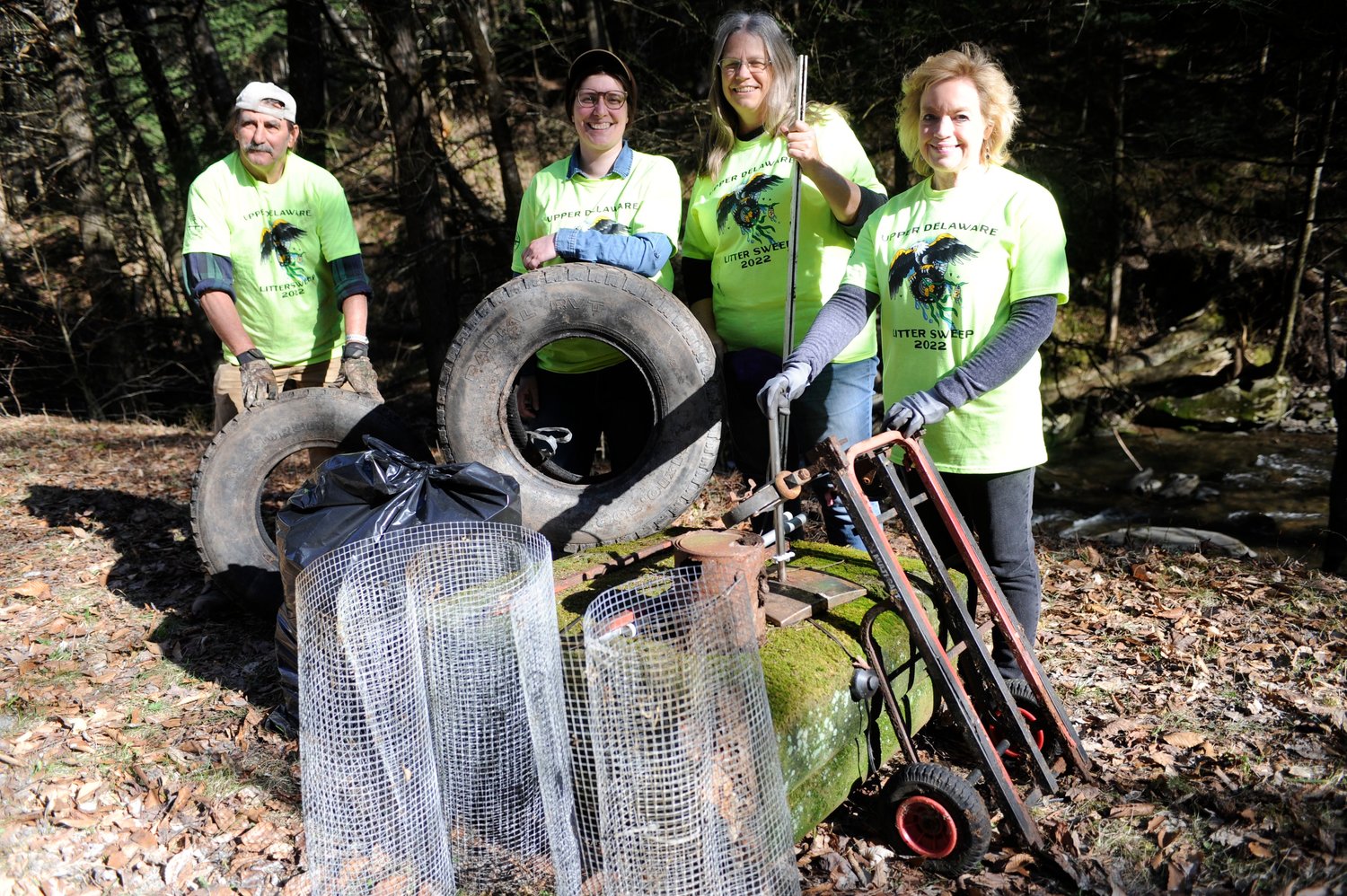 A fine haul. Volunteers clean up an old illegal dumpsite: Dan Bowers, left; Ashley Hall-Bagdonas; Kate Sykes Bowers and Laurie Ramie.