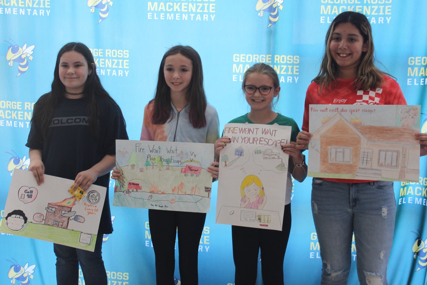 Proudly displaying their posters are George Ross Mackenzie students Brooke Ranne, left; Hailee Gutman; Sydney Moscatiello; and Mia Vazquez.