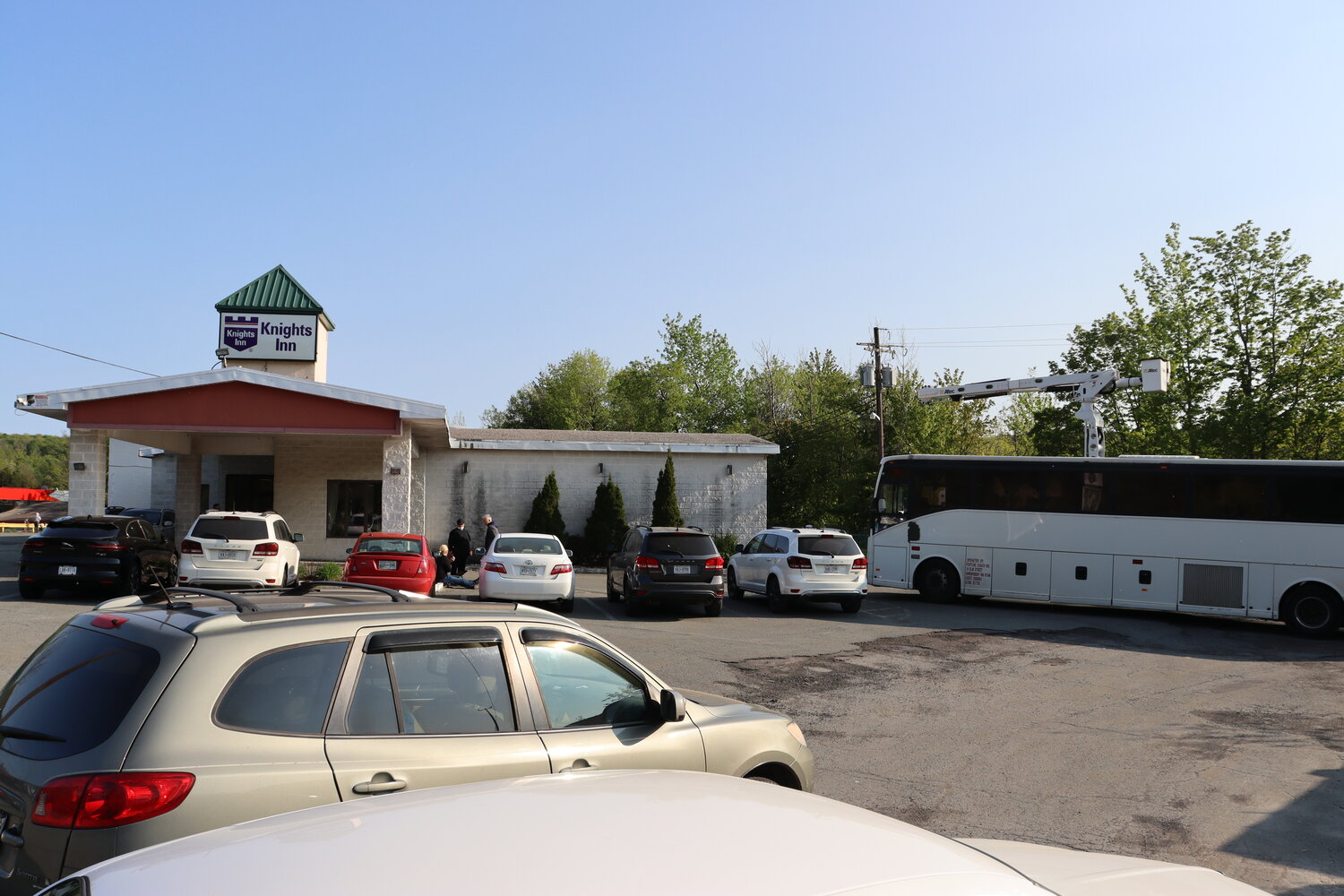 A buss from New York City is pulled up outside the Knights Inn in Liberty on Thursday, May 18, bringing asylum seekers from the city.