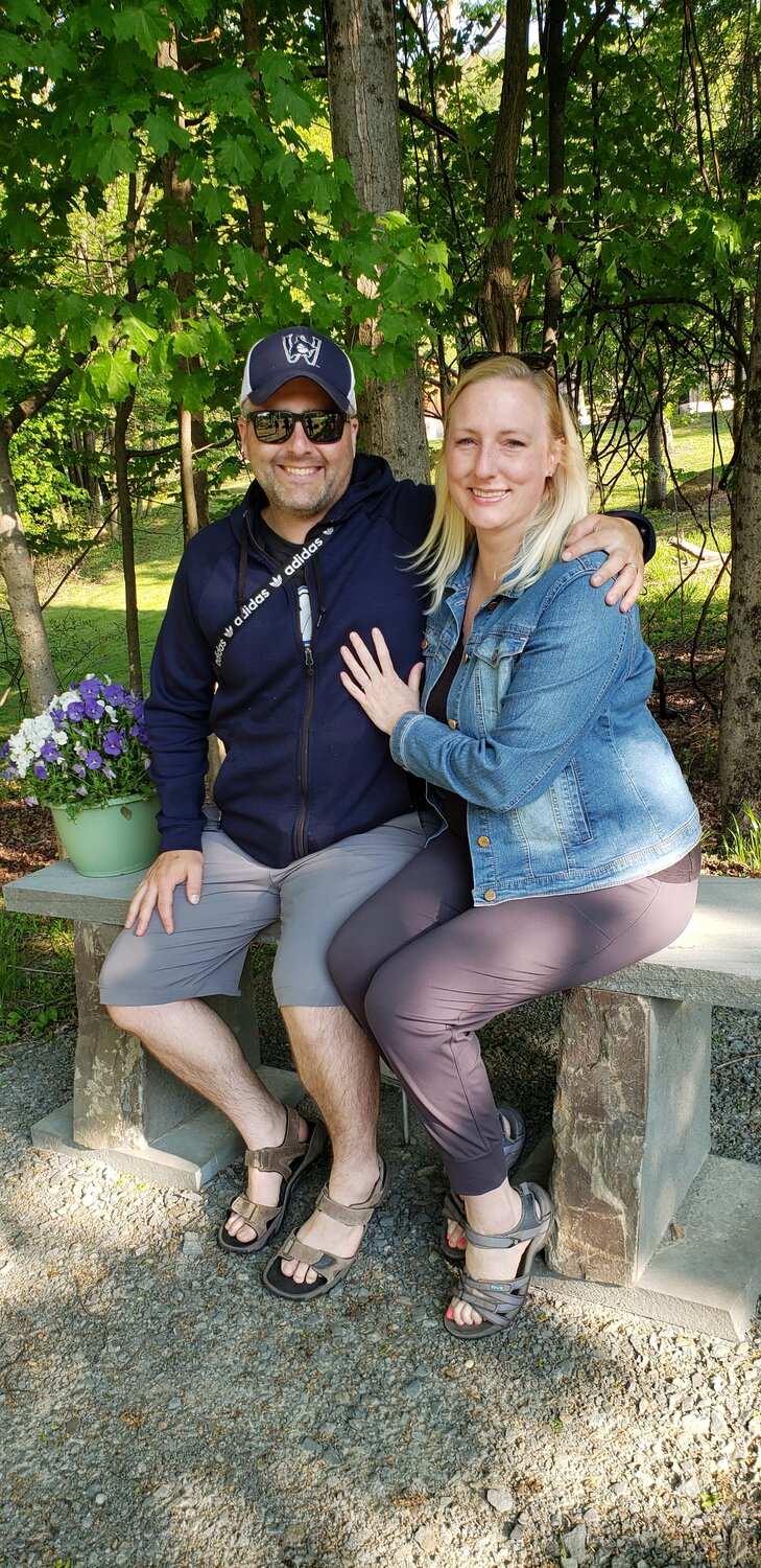 Lisa Aspessi, Rolf Beckhusen's daughter, right, and her husband, James, traveled to Bellingham, WA to the Upper Delaware to sit on the memorial bench erected on the former Beckhusen homestead, now a part of Kittatinny Campgrounds.
